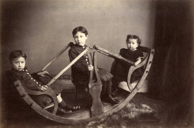 Three Siblings Playing on Their Rocking See-Saw, 1880s by J. S. Brown
